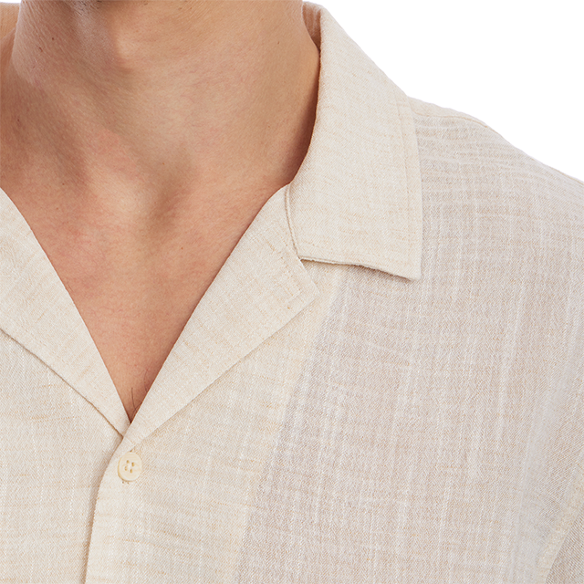 Close-up of a beige shirt with a collar on a white background