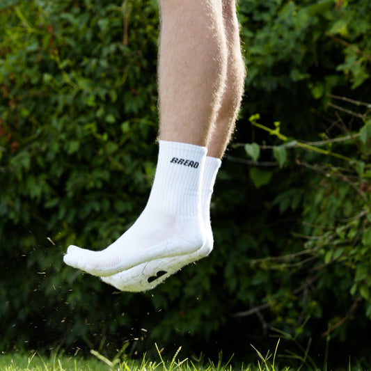 White crew socks with small black logo lettering