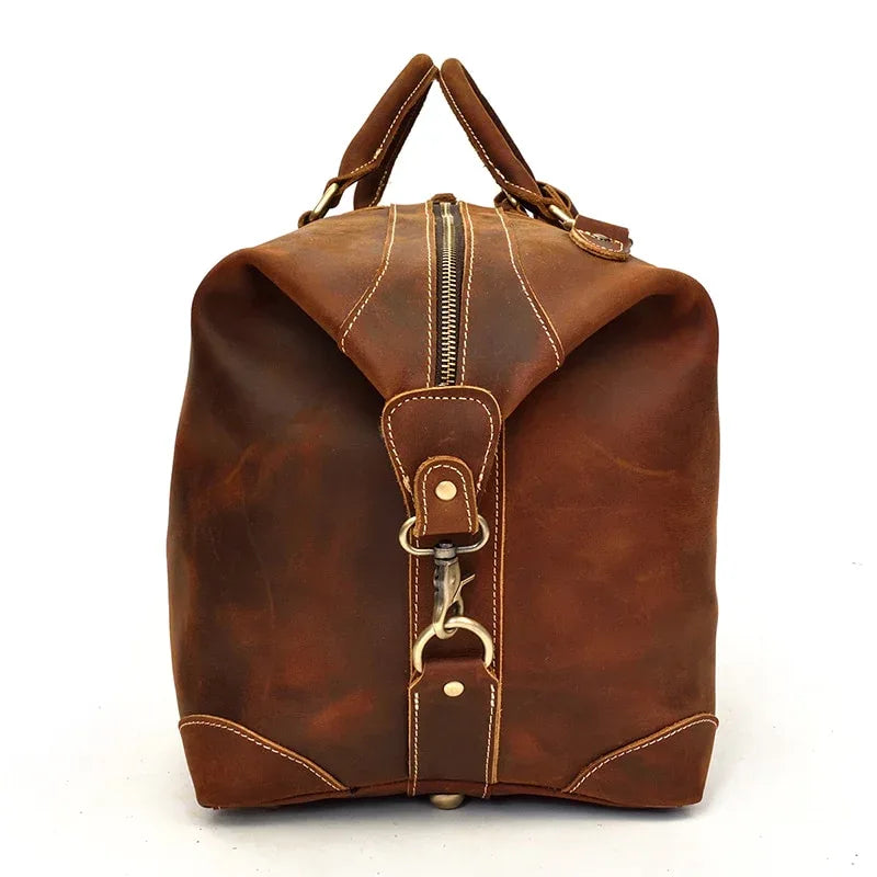 Brown leather duffle bag with top handles, front zipper, and metal clasp