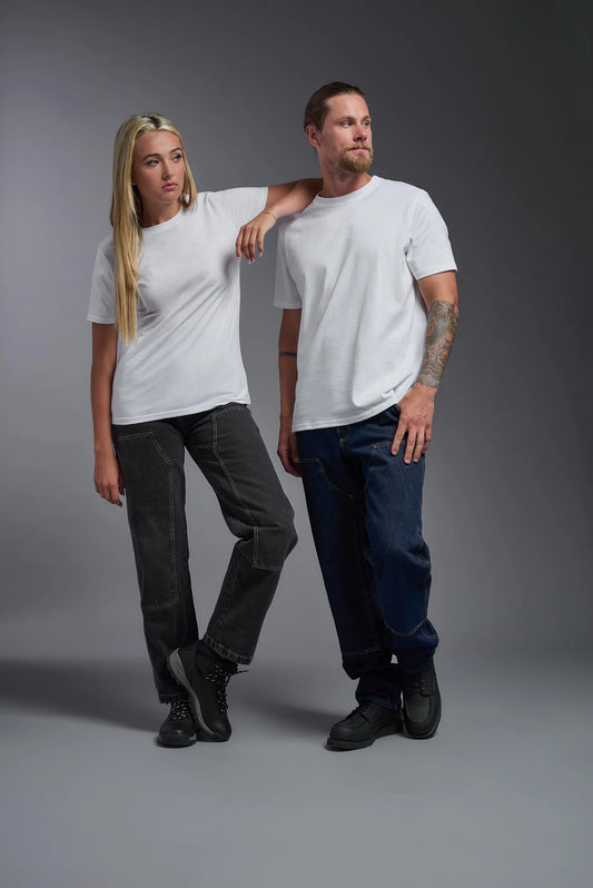 Two people wearing white t-shirts and dark pants against a gray background