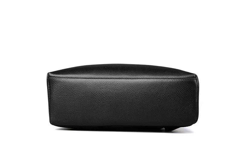 Bottom view of a black leather slim backpack with textured finish and flat base