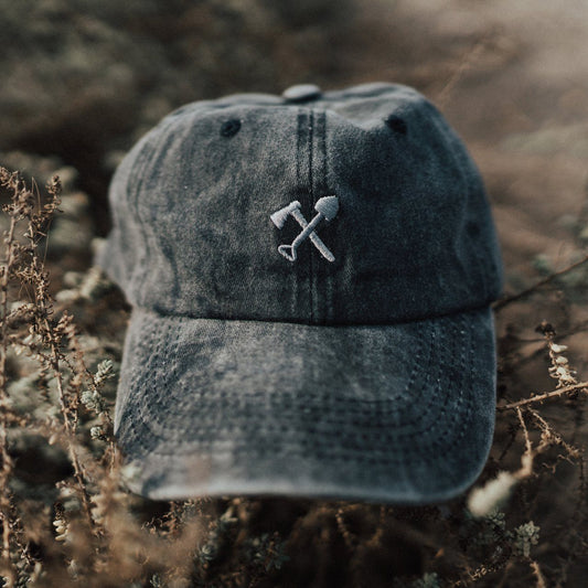 Denim cap with embroidered design on a natural background