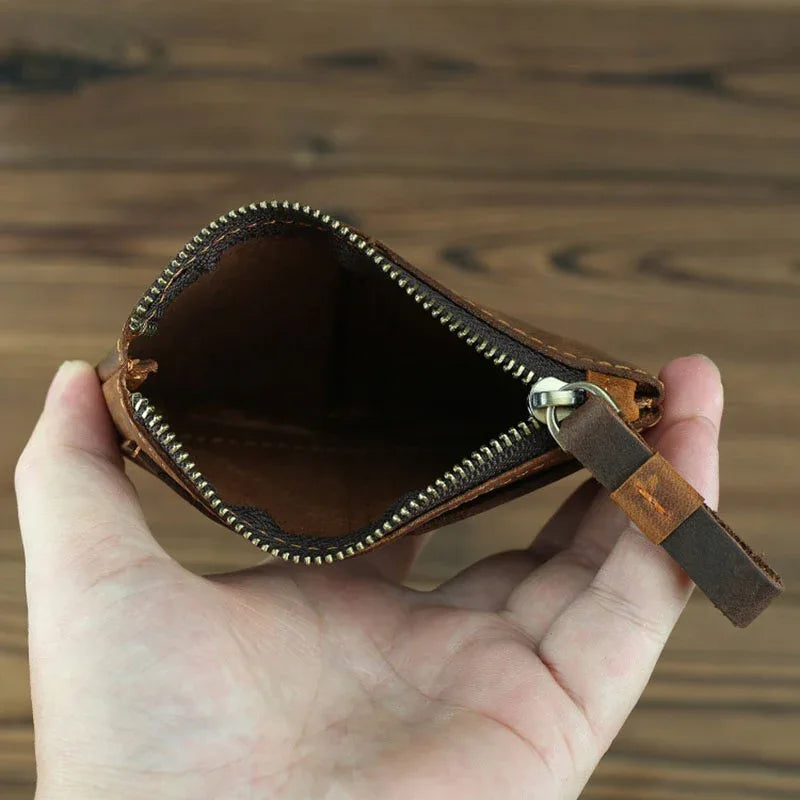 Brown leather coin purse interior view with zipper and stitched inner lining.