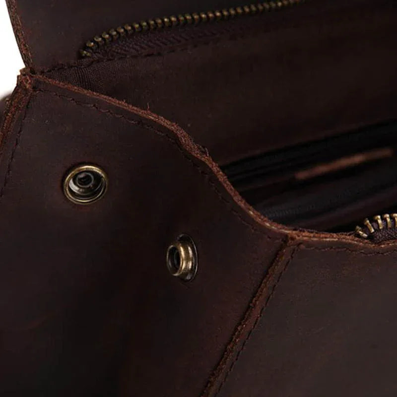 Interior-side view of dark brown leather with grommet snaps and stitched seams