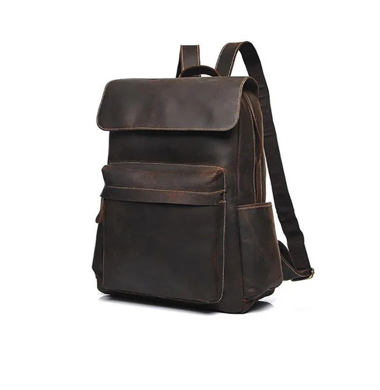 Vintage leather laptop backpack in dark brown, side view with adjustable shoulder strap.