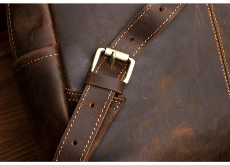 Vintage leather backpack strap with metal buckle and stitching