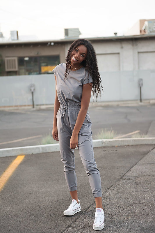 Plain Grey Jumpsuit model in a parking lot front view