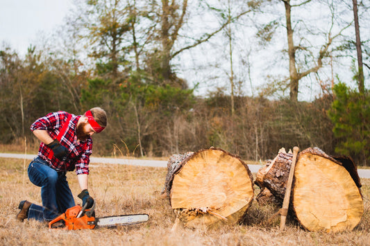 Flannel shirt image of a man cutting a log