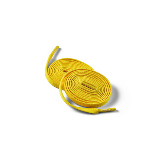 Yellow shoelaces on a white background