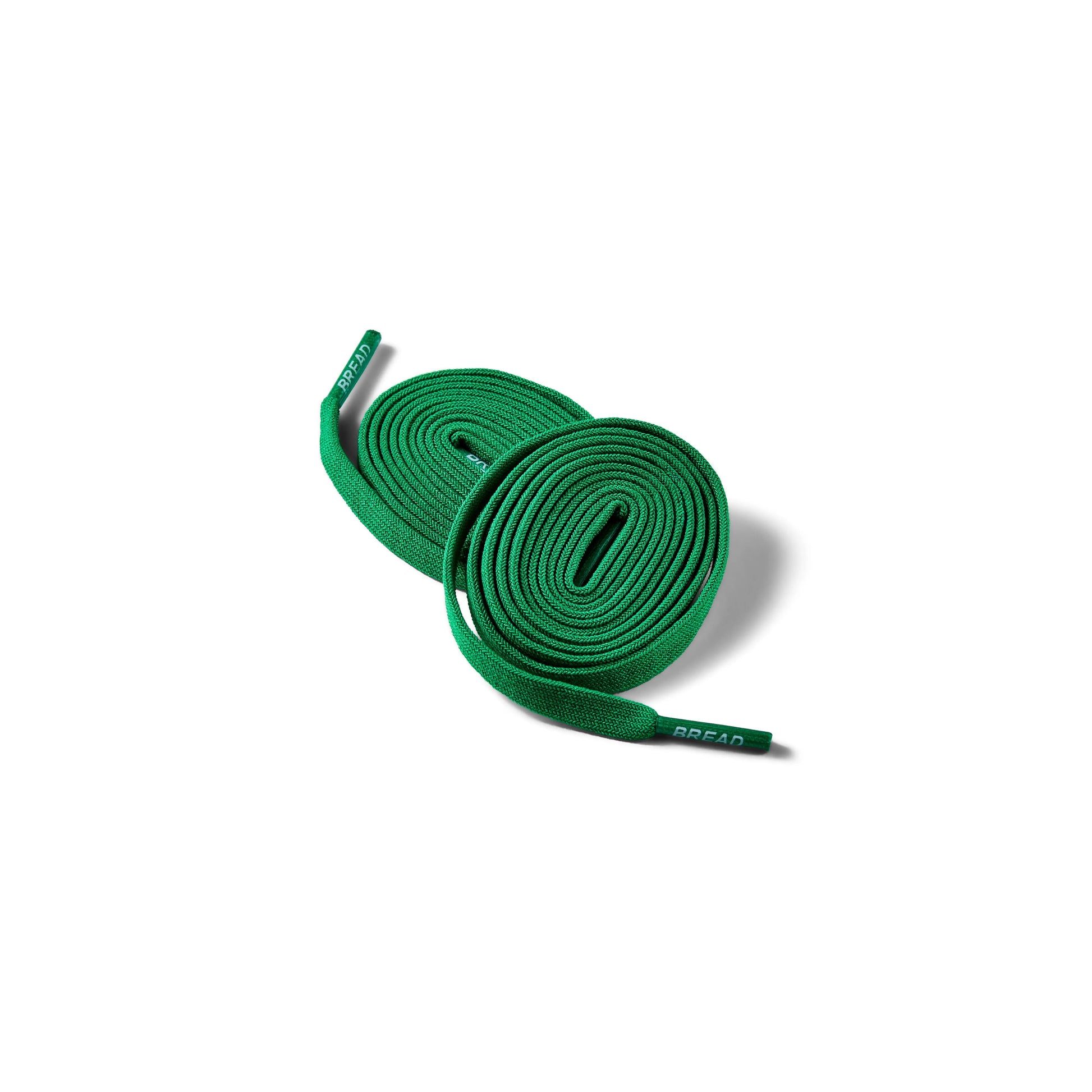 Green shoelaces on a white background