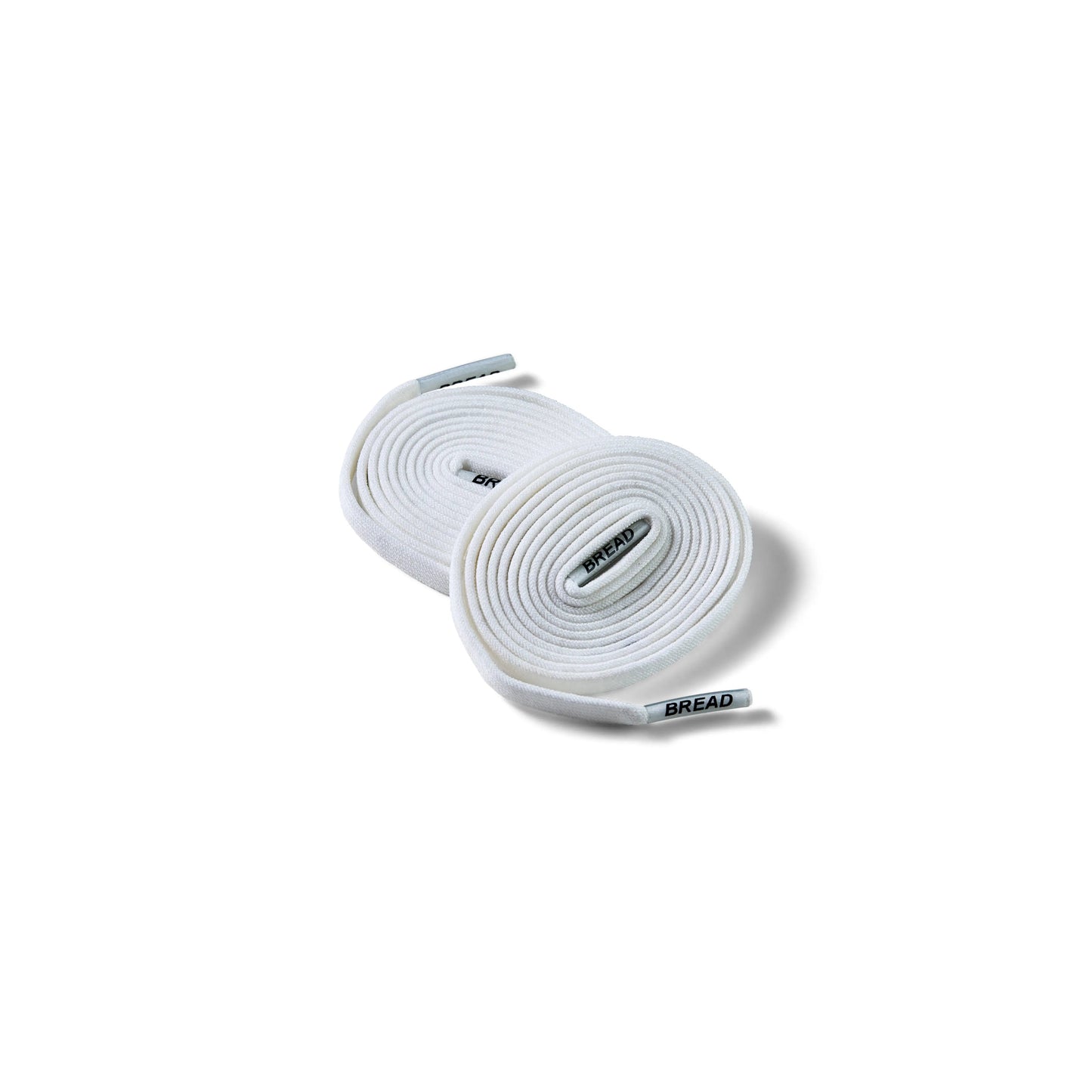 Two rolls of white shoelaces on a white background