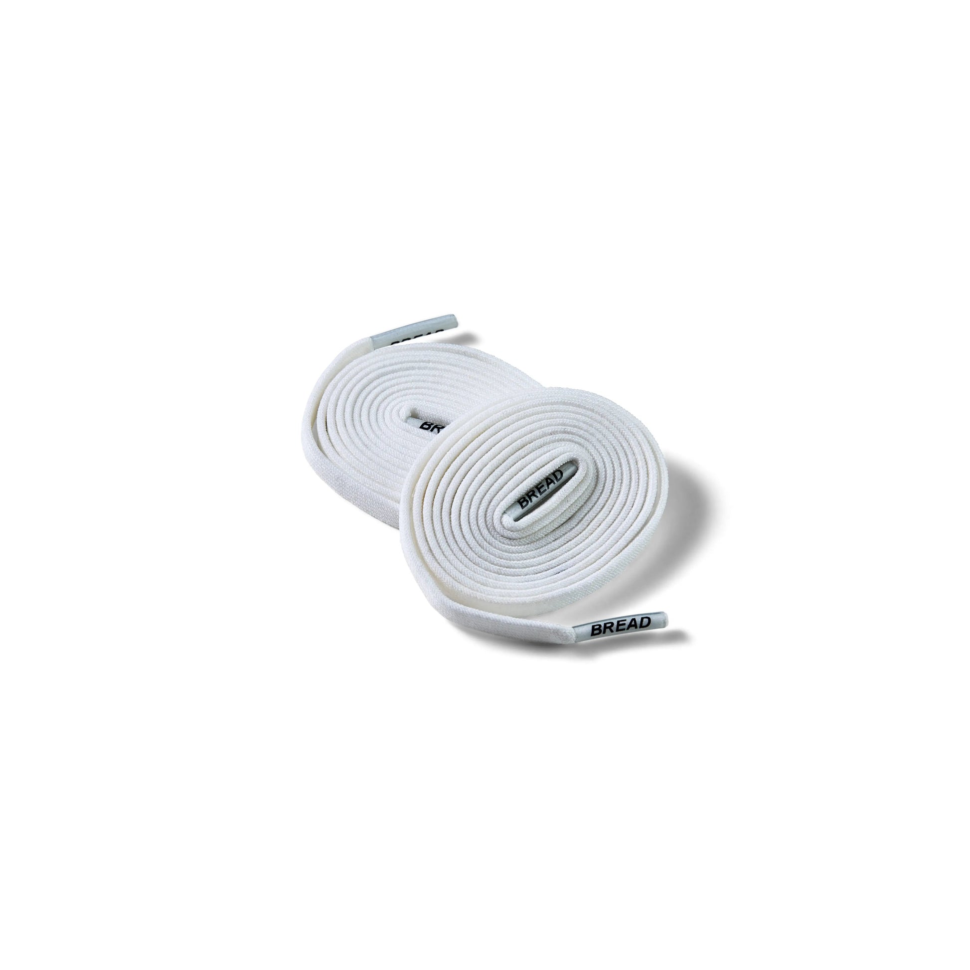 Two rolls of white shoelaces on a white background