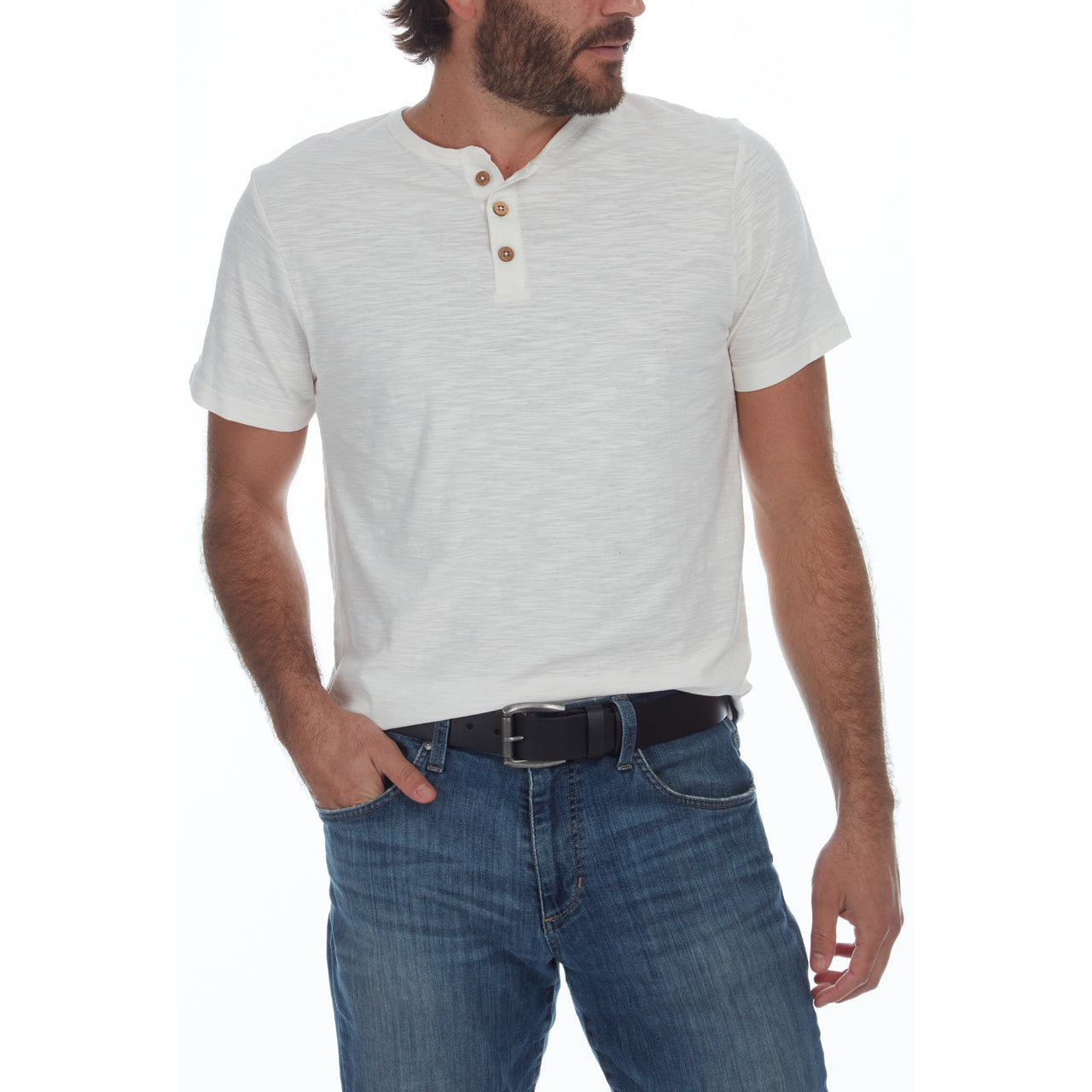 Man wearing a white short-sleeve henley shirt and blue jeans on a white background