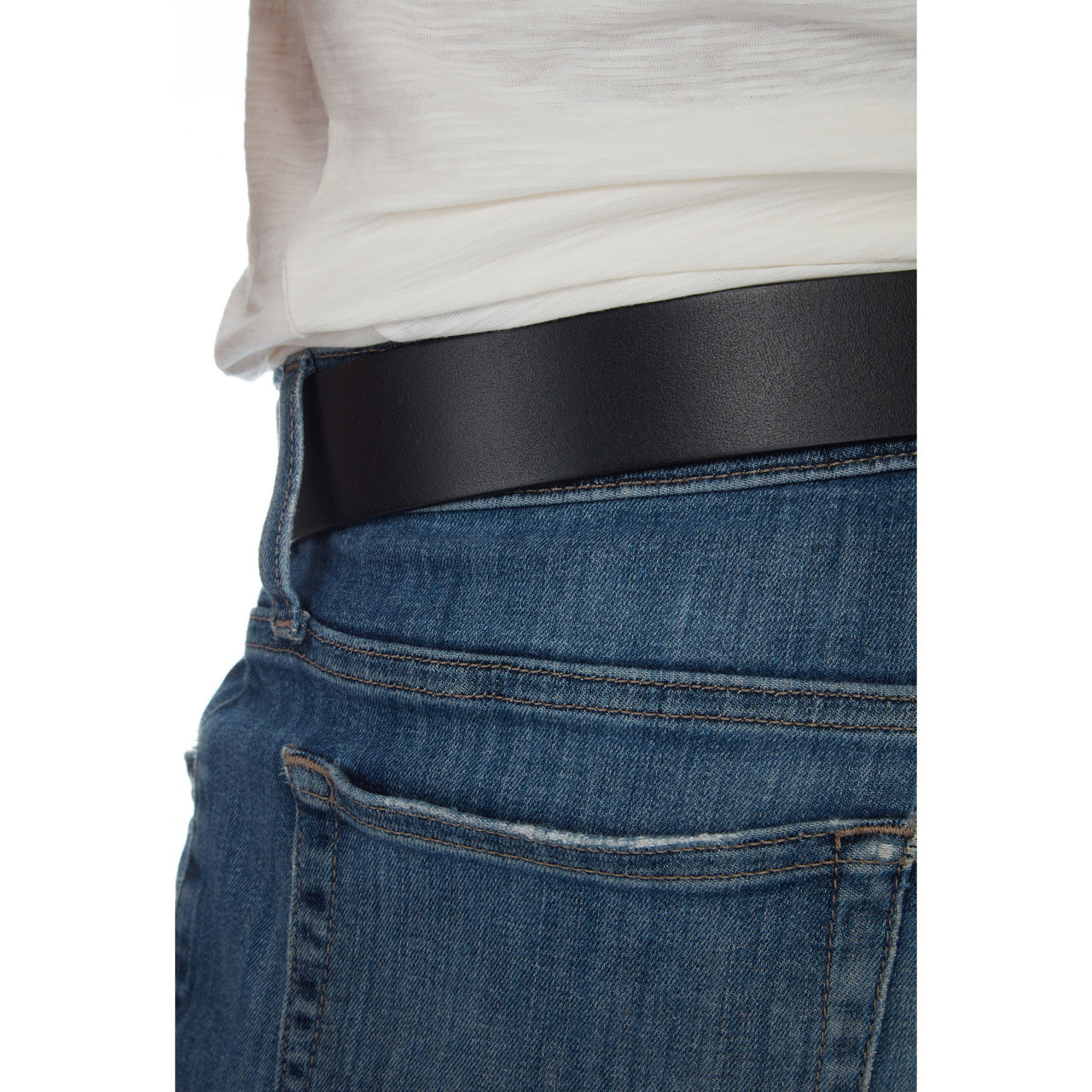 Person wearing a black belt and blue jeans on a white background