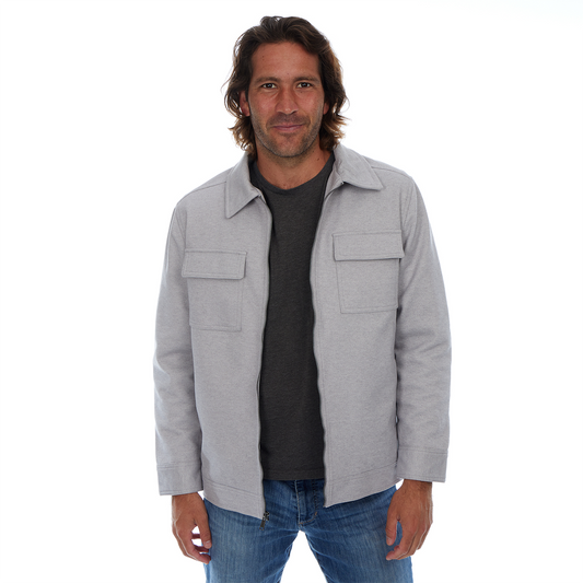 Man wearing a gray jacket over a black shirt on a white background