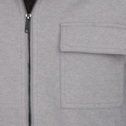 Close-up of a gray jacket with a zipper and pocket