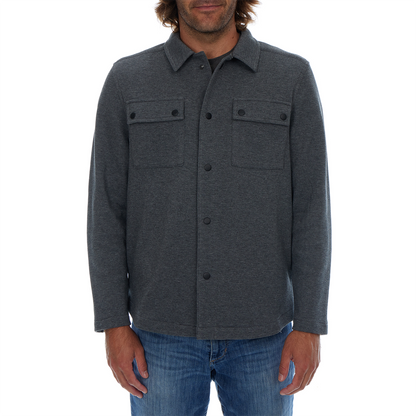 Man wearing a dark gray button-up shirt with a white background