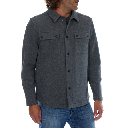 Man wearing a gray button-up shirt with two front pockets on a white background