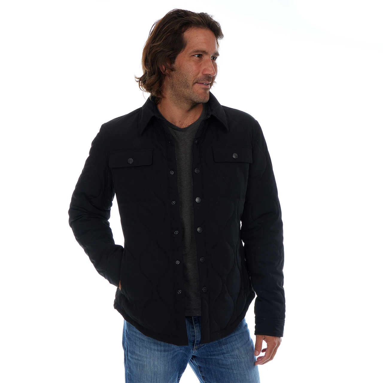 Man wearing a black jacket and blue jeans on a white background