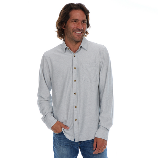 Man wearing a light gray button-up shirt with a white background