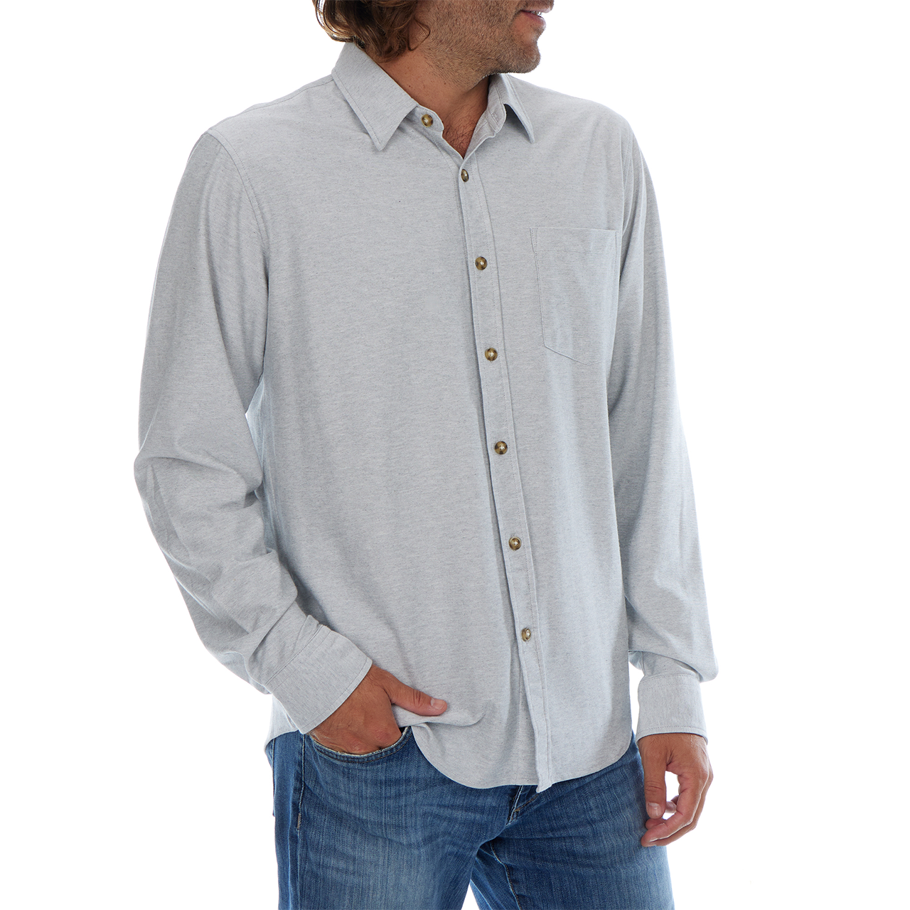 Man wearing a light gray button-up shirt and blue jeans on a white background