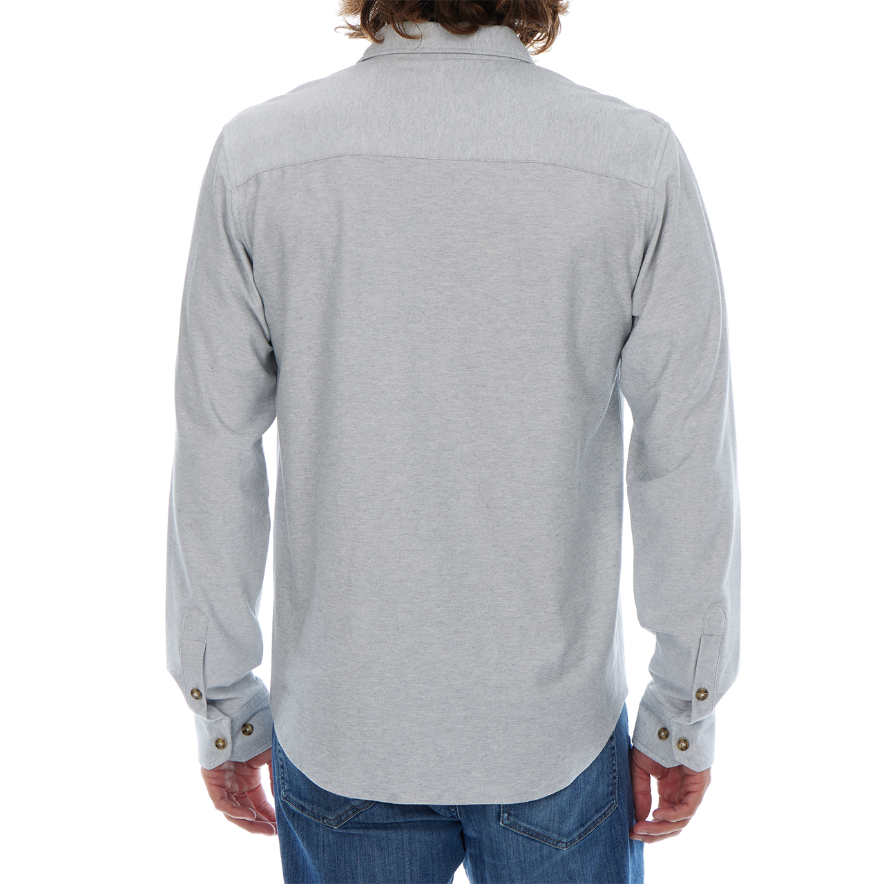 Person wearing a light gray button-up shirt and blue jeans on a white background
