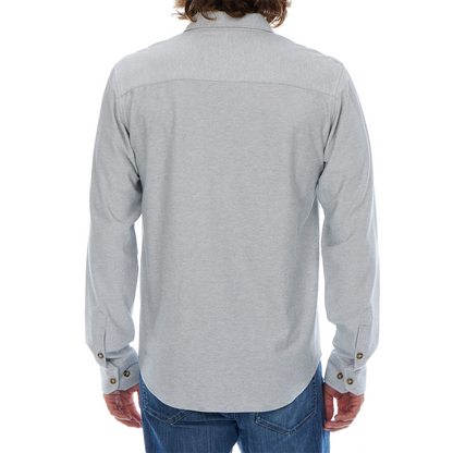 Person wearing a light gray button-up shirt and blue jeans on a white background