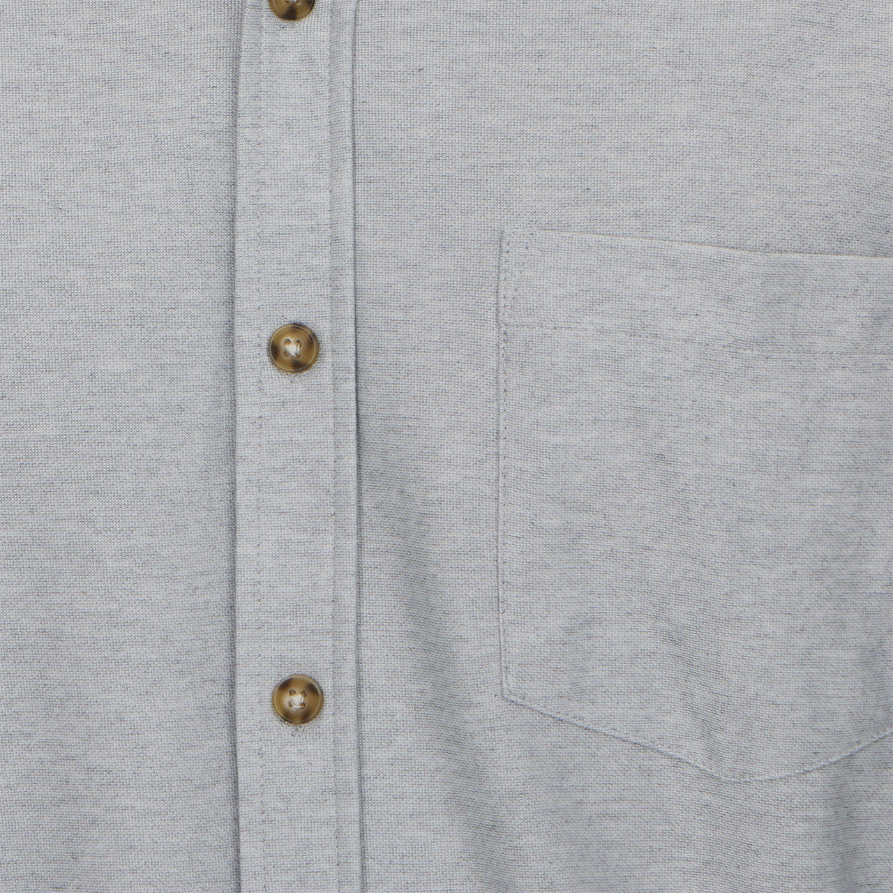 Close-up of a gray shirt with button details