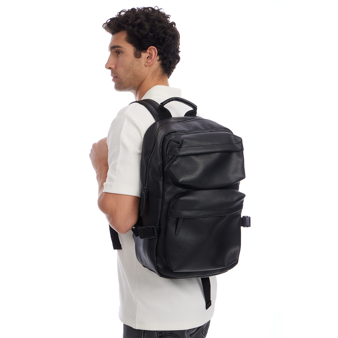 Man wearing a black leather backpack on a white background