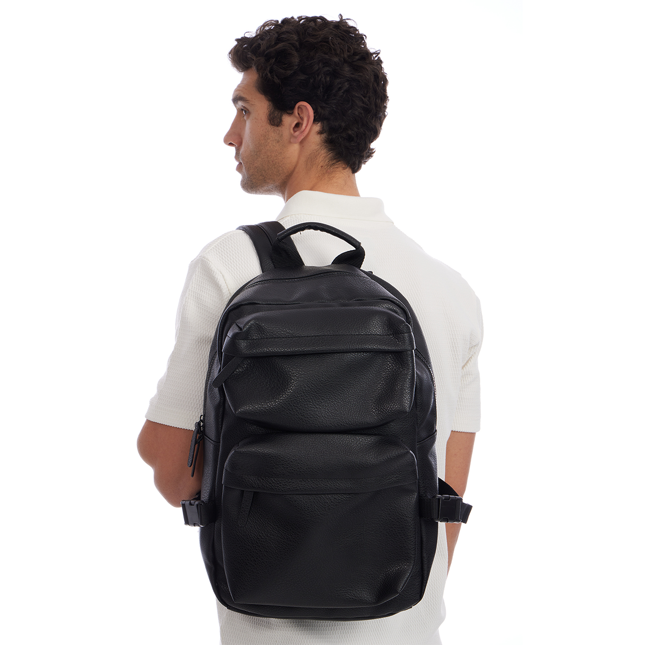 Man wearing a black backpack on a white background