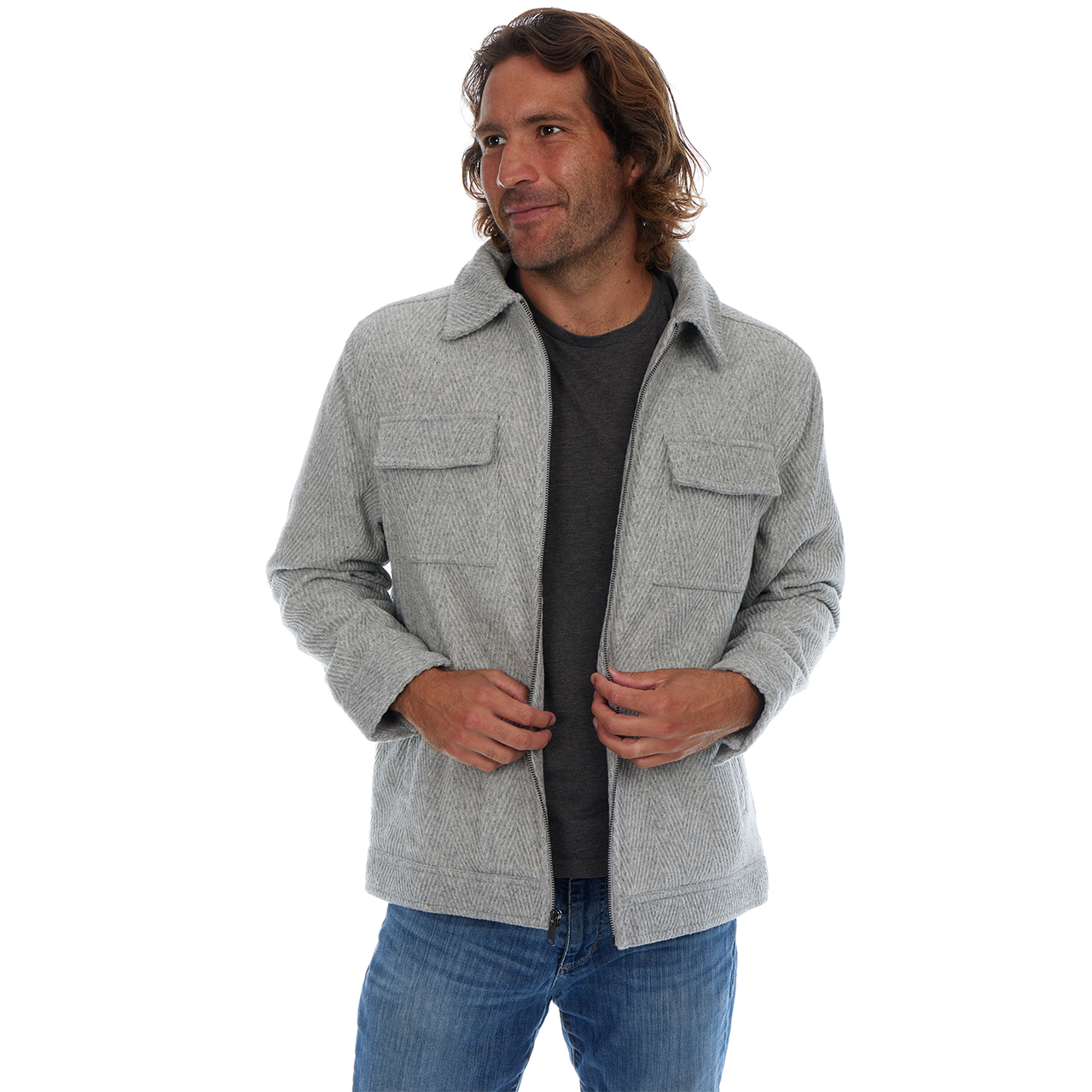Man wearing a gray jacket and blue jeans on a white background