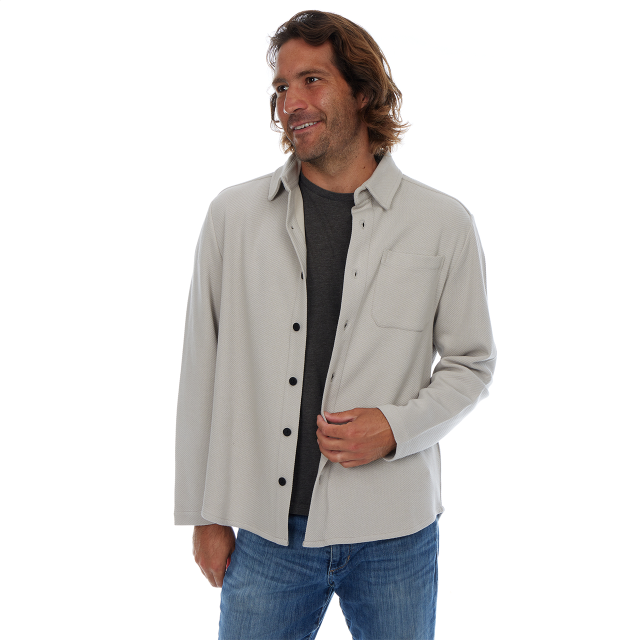 Man wearing a light gray jacket over a black shirt and blue jeans on a white background