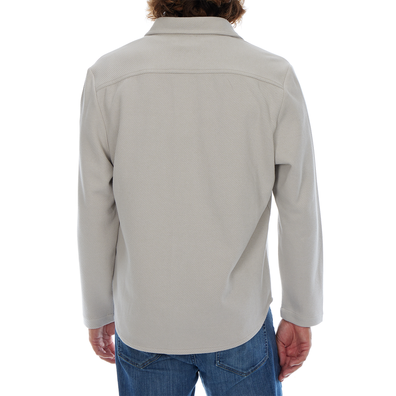 Person wearing a light gray jacket and blue jeans on a white background