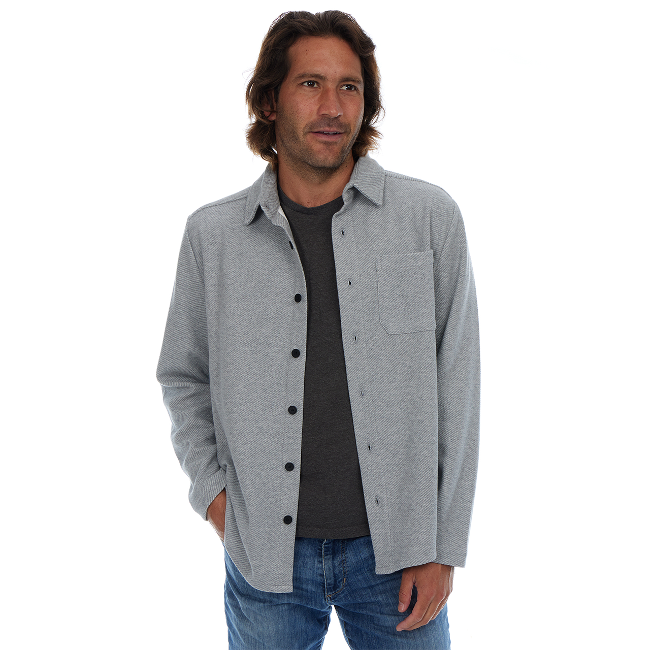 Man wearing a gray button-up shirt over a black t-shirt on a white background