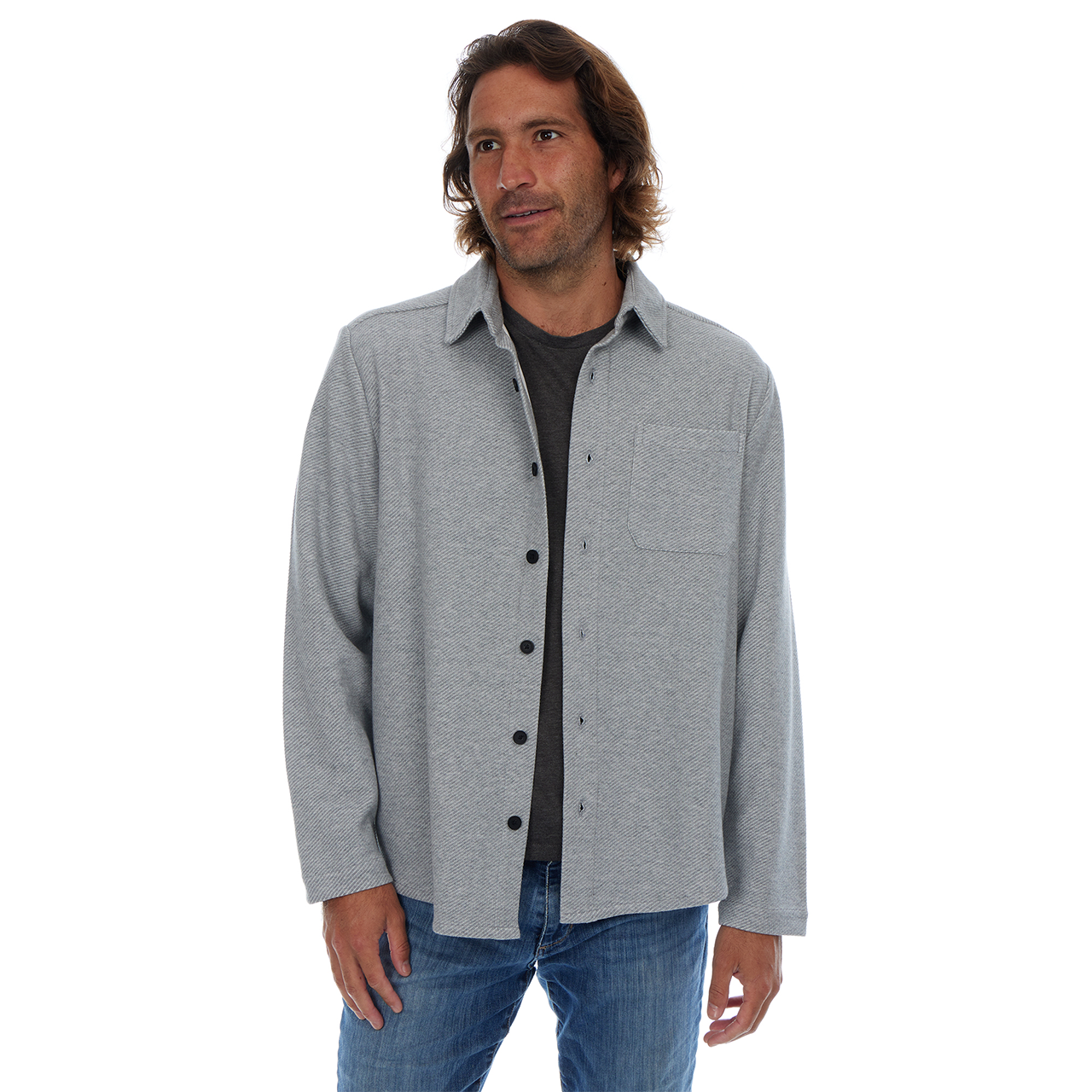 Man wearing a gray button-up shirt over a black shirt on a white background