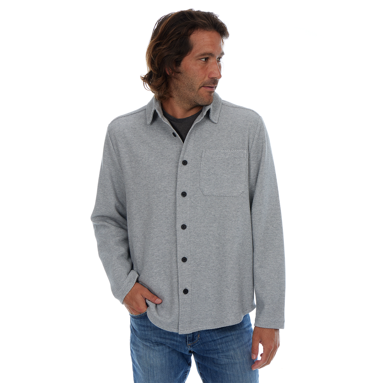 Man wearing a gray button-up shirt and blue jeans on a white background
