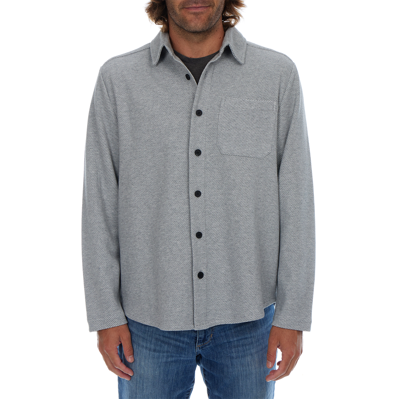 Man wearing a gray button-up shirt with a white background