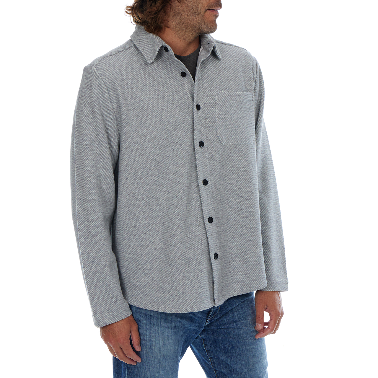 Man wearing a gray button-up shirt and jeans on a white background