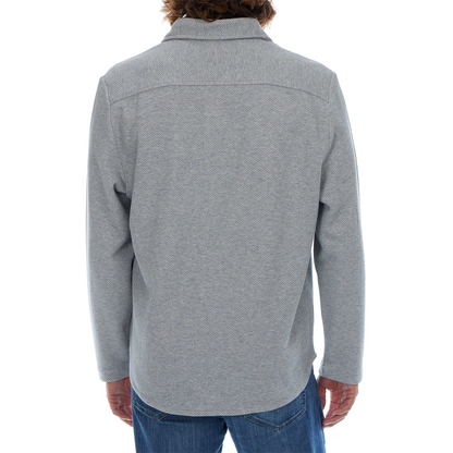 Person wearing a gray patterned shirt on a white background