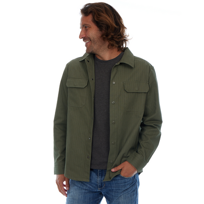 Man wearing an olive green shirt with two front pockets on a white background
