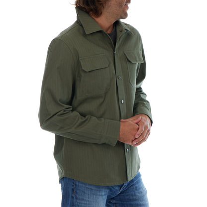 Man wearing a green shirt with rolled-up sleeves on a white background