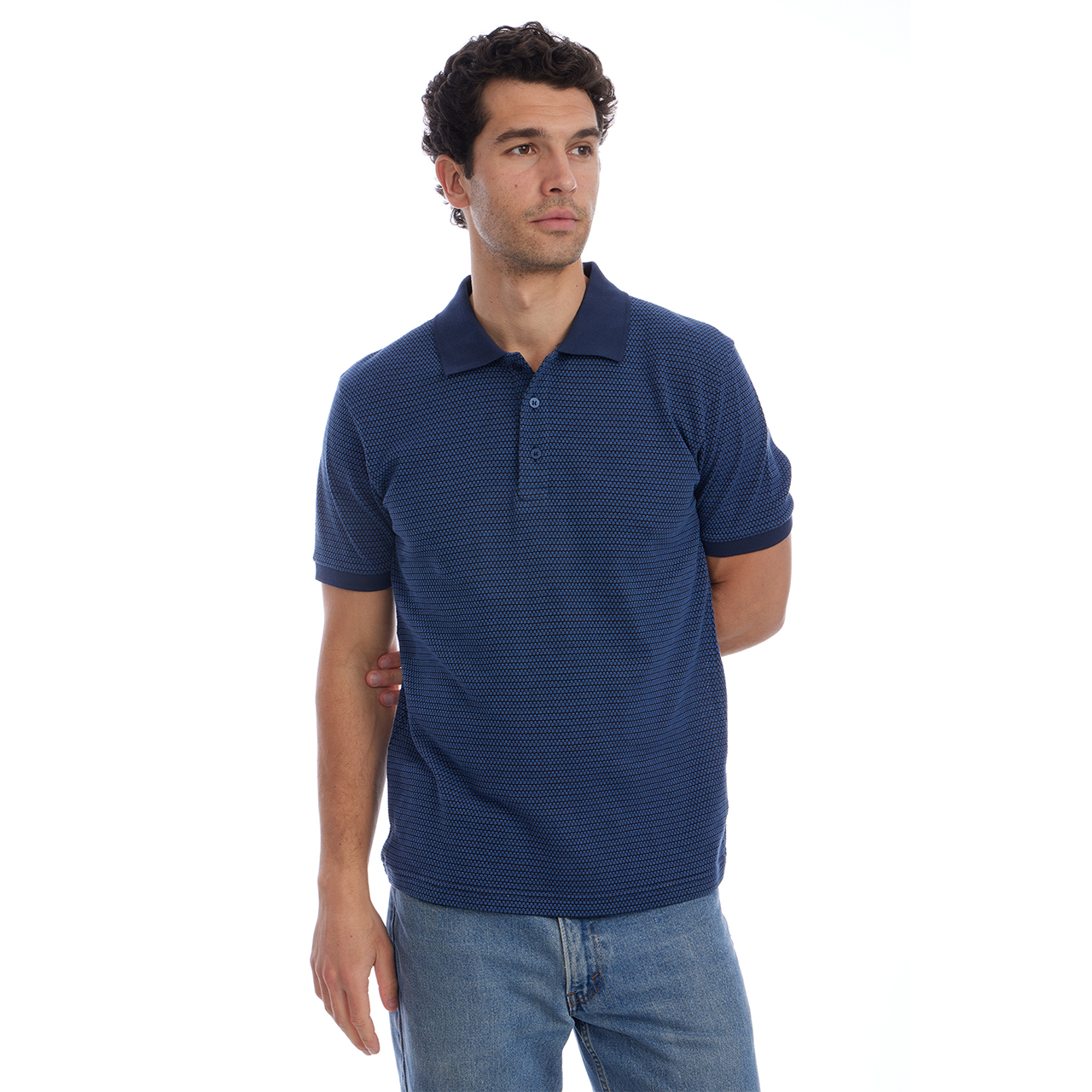 Man wearing a blue polo shirt and jeans on a white background