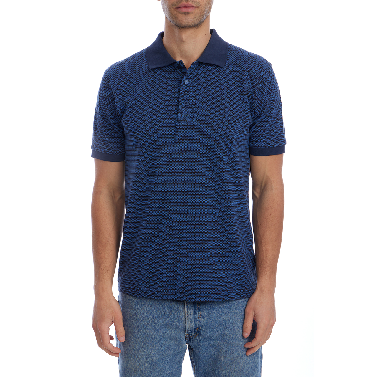 Man wearing a blue patterned polo shirt and jeans on a white background