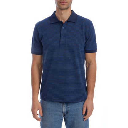 Man wearing a blue patterned polo shirt and jeans on a white background