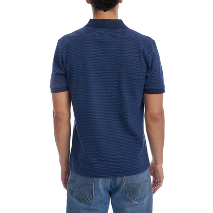 Person wearing a blue textured polo shirt on a white background
