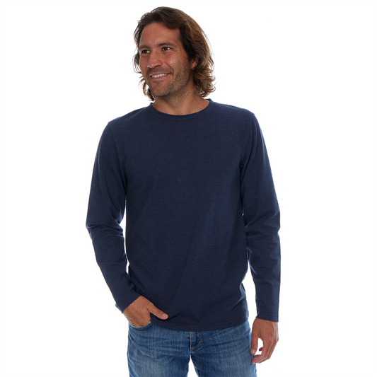 Man wearing a navy long-sleeve shirt and blue jeans on a white background