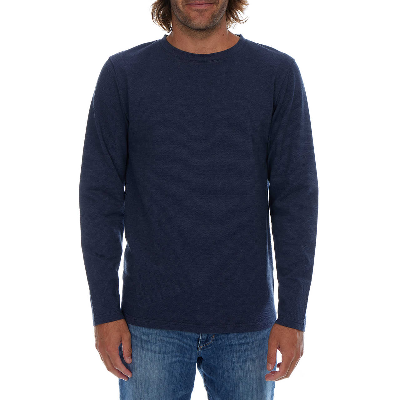 Man wearing a navy long-sleeve shirt and jeans on a white background
