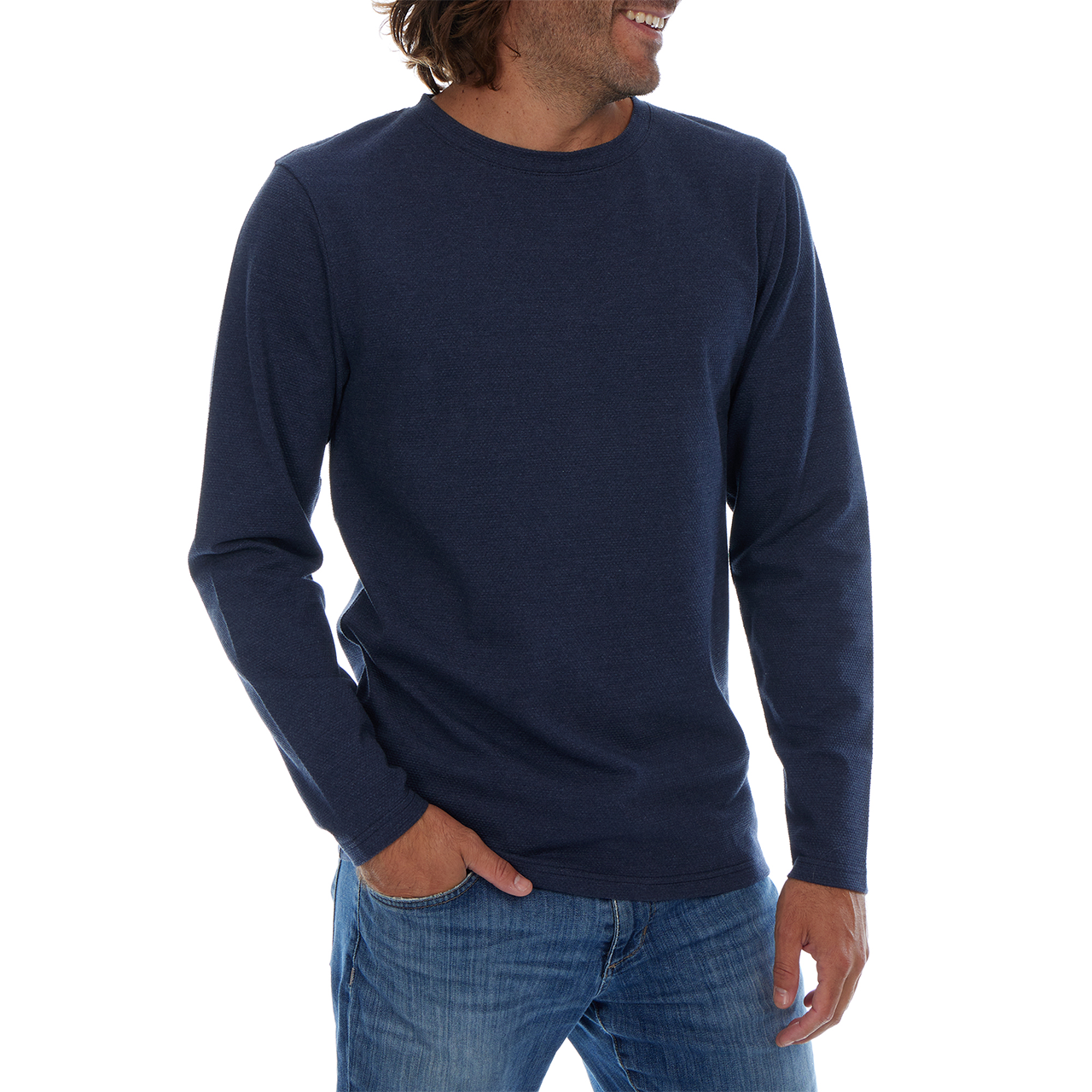 Man wearing a navy long-sleeve shirt and blue jeans on a white background
