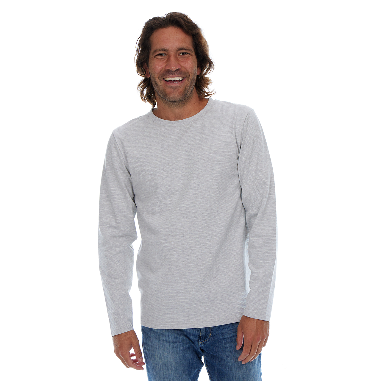 Man wearing a gray long-sleeve shirt and blue jeans on a white background
