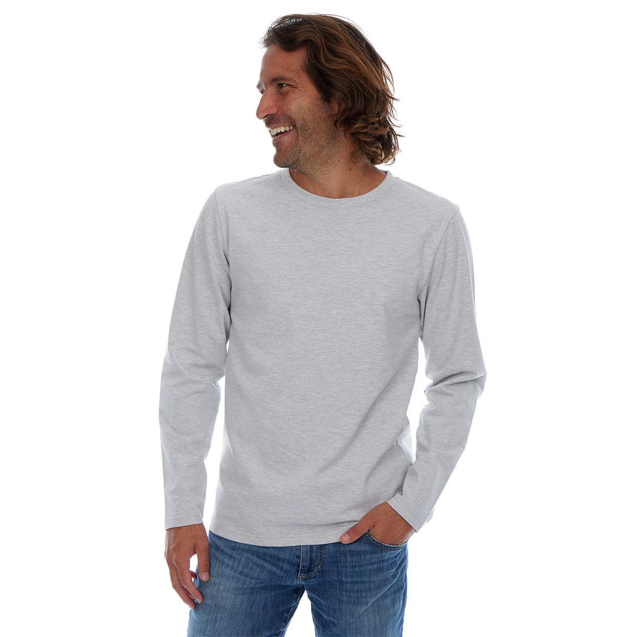Man wearing a gray long-sleeve shirt and blue jeans on a white background
